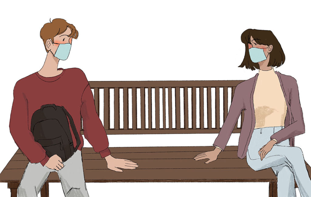 couple sits on bench 6 ft apart